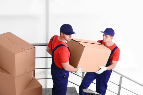 Removal van and moving team working on a Sutton residential street