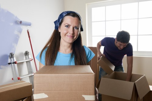 Professional movers handling desks and office items during a Sutton relocation