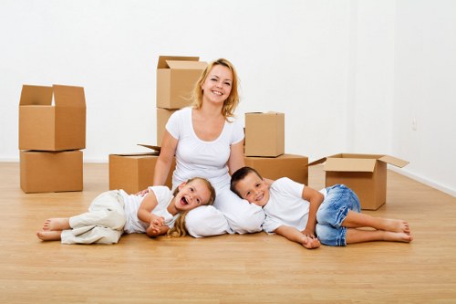 Packed moving boxes and furniture ready for transport in Sutton