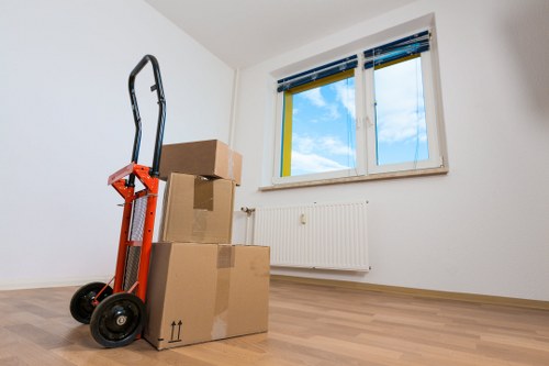Moving team handling fragile boxes and furniture during a Sutton move