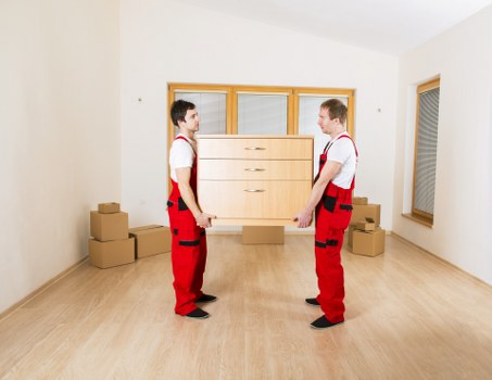 Local furniture collection team removing sofa and bed frame in Sutton